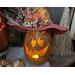 This fall pumpkin is lit up with a battery-operated candle. He's looking up towards silly eyelashes, his big smile shows three big teeth. 